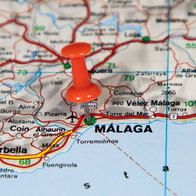 A pin on a map marking the city of Malaga in Southern Spain