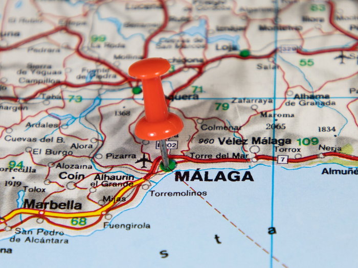 A pin on a map marking the city of Malaga in Southern Spain