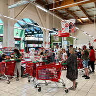 People in queue at a supermarket tills with their trolleys full of shopping