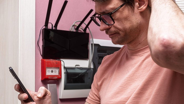 man frustrated with Internet on phone