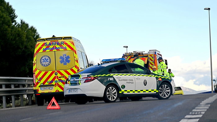 An ambulance, police car and fire truck stationed on a motorway attending an accident