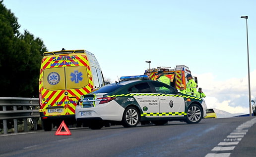 An ambulance, police car and fire truck stationed on a motorway attending an accident
