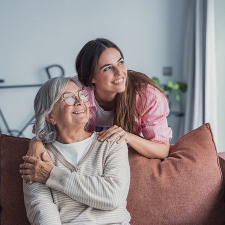 Loving adult daughter hugging older mother,