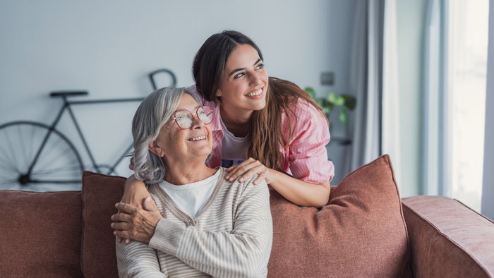 Loving adult daughter hugging older mother,
