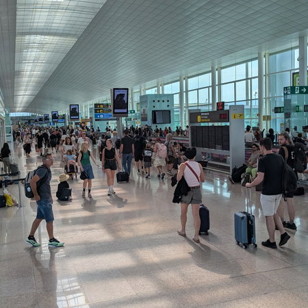 An airport filled with passengers walking to their terminals