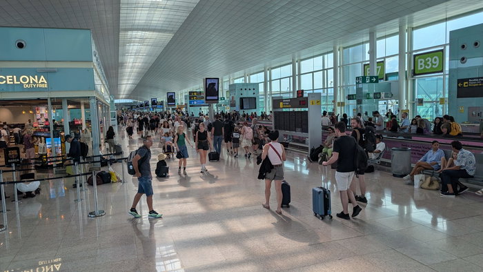 An airport filled with passengers walking to their terminals